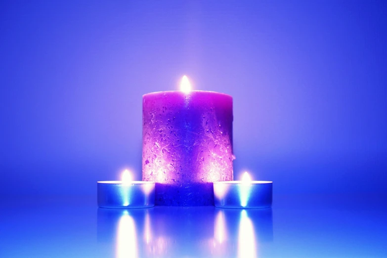 three lit candles sitting on top of a table, blue purple gradient, ambient volumetric lighting, serenity & calm, neon purple