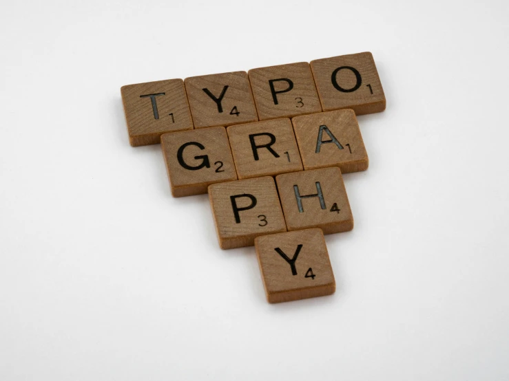 a close up of scrabbles on a white surface, a picture, international typographic style, brand mark, tyftt, phograph, thumbnail
