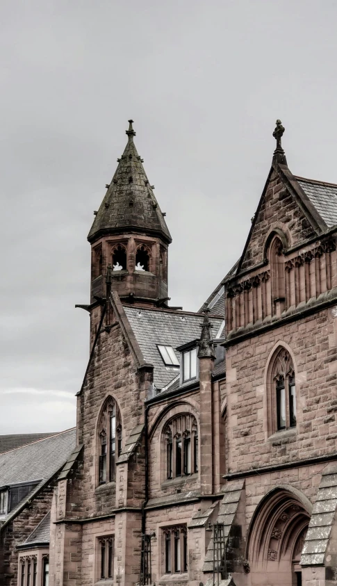 a large brick building with a clock tower, by Andrew Robertson, pexels contest winner, romanesque, paisley, panoramic shot, grey, the narthex