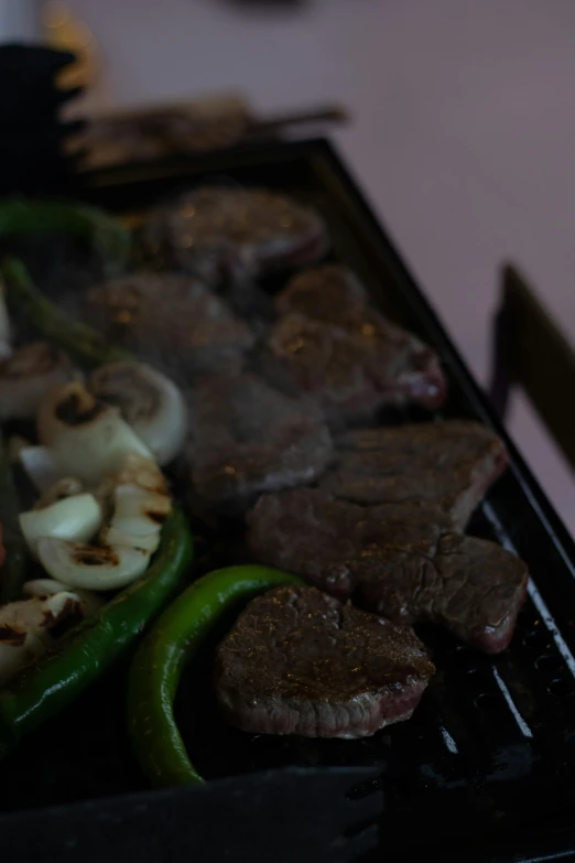 a close up of a grill with meat and vegetables on it, by Alejandro Obregón, low quality photo, けもの, 2 0 5 6