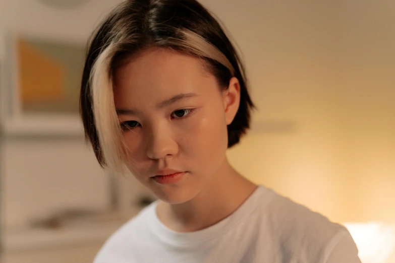 a woman in a white shirt looking at a cell phone, a character portrait, inspired by Kim Tschang Yeul, trending on pexels, hyperrealism, short platinum hair tomboy, sad lighting, half asian, parted hair