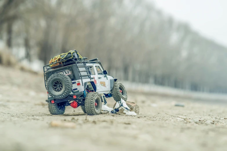 a toy truck sitting on top of a sandy beach, by Adam Marczyński, unsplash, photorealism, jeep wrangler, !!highly detailed!!, abandoned vehicles, spring season