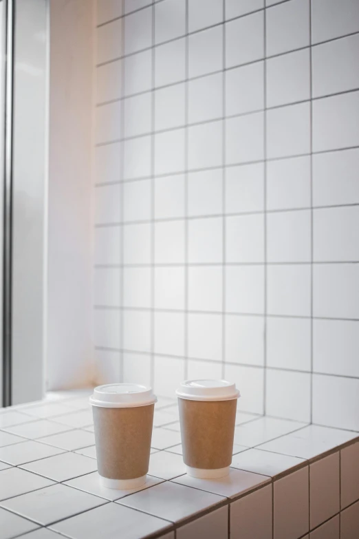 two cups of coffee sitting on top of a counter, by Harvey Quaytman, minimalism, made of all white ceramic tiles, promo image, 2 5 6 x 2 5 6 pixels, japanese akihabara cafe