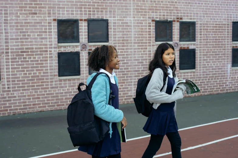 a couple of girls walking across a tennis court, pexels, american barbizon school, girl wearing uniform, with a backpack, aida muluneh, filmstill