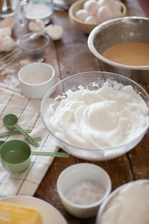 a wooden table topped with bowls of food, process art, whipped cream on top, goop, soft and fluffy, background image