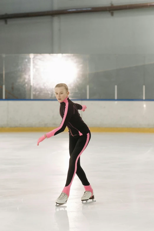 a young girl skating on an ice rink, arabesque, in spandex suit, mandy jurgens 8 k 1 5 0 mpx, f/1.2, a blond