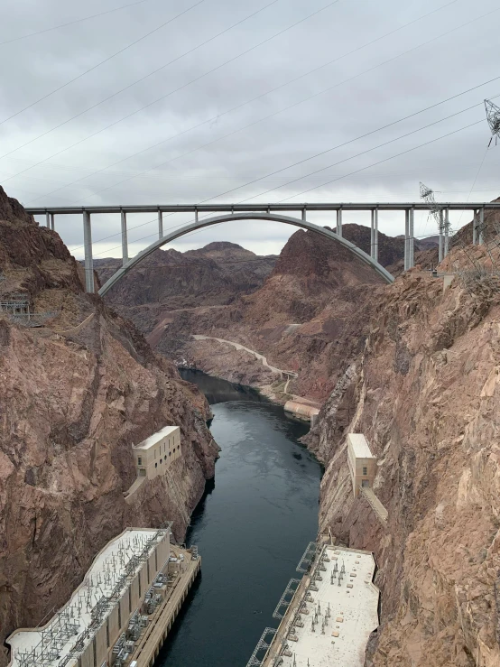 a bridge over a large body of water, top of a canyon, bernie goes to vegas, thumbnail, electrical arcs