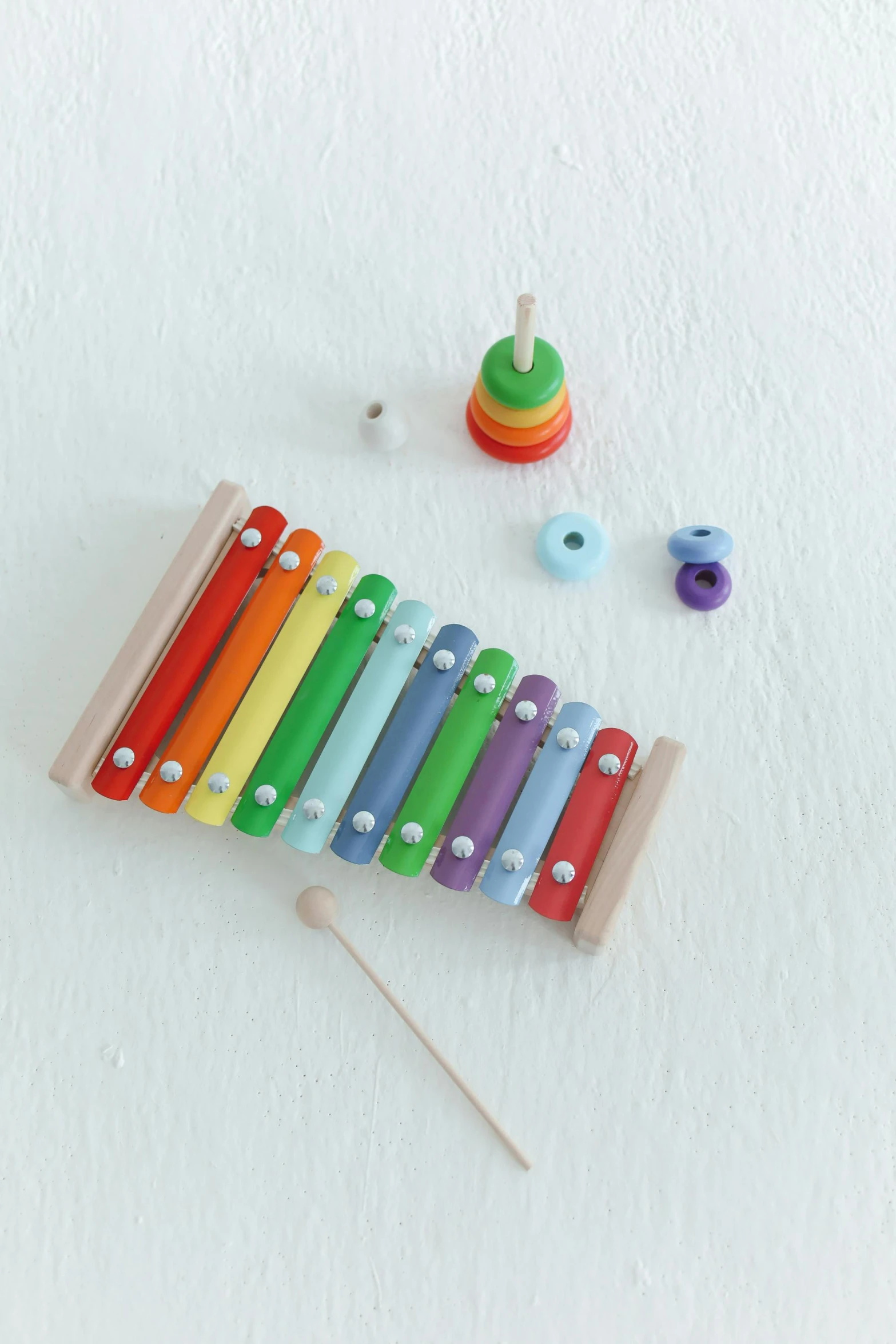 a close up of a musical instrument on a white surface, inspired by Jan Rustem, unsplash, children's toy, multiple colors, eco, scandinavian