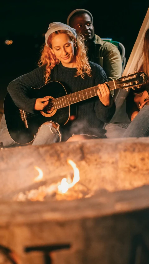 a group of people sitting around a fire pit, an album cover, pexels contest winner, the girl plays the guitar, 15081959 21121991 01012000 4k, detail shot, teenage girl