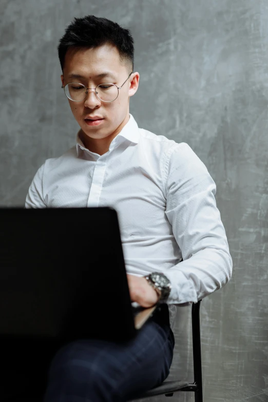 a man sitting in front of a laptop computer, inspired by Fei Danxu, trending on pexels, formal attire, wearing white shirt, half man half asian black bull, engineer