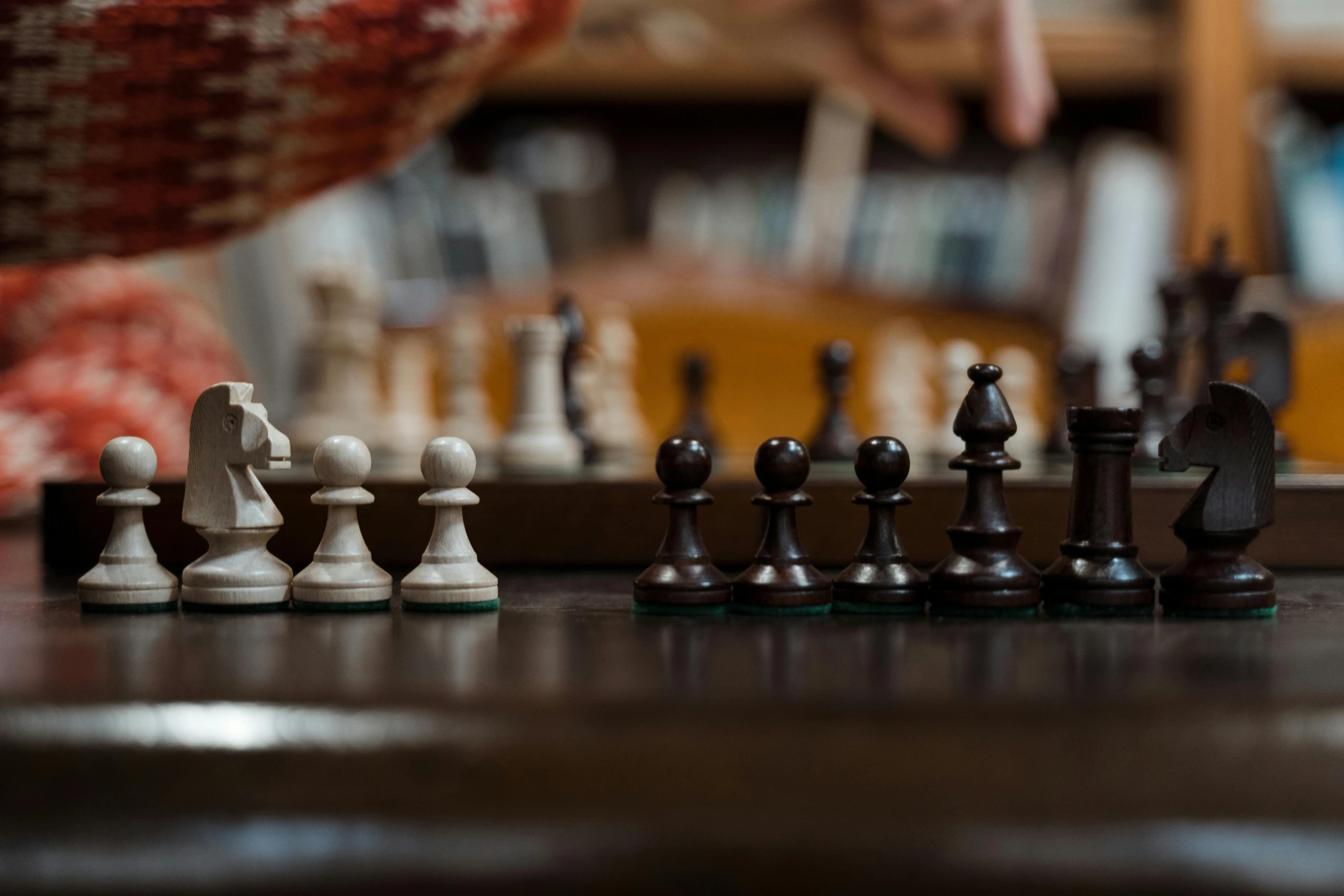 a close up of chess pieces on a table, unsplash, closeup of arms, jen atkin, on a wooden tray, stewart cowley