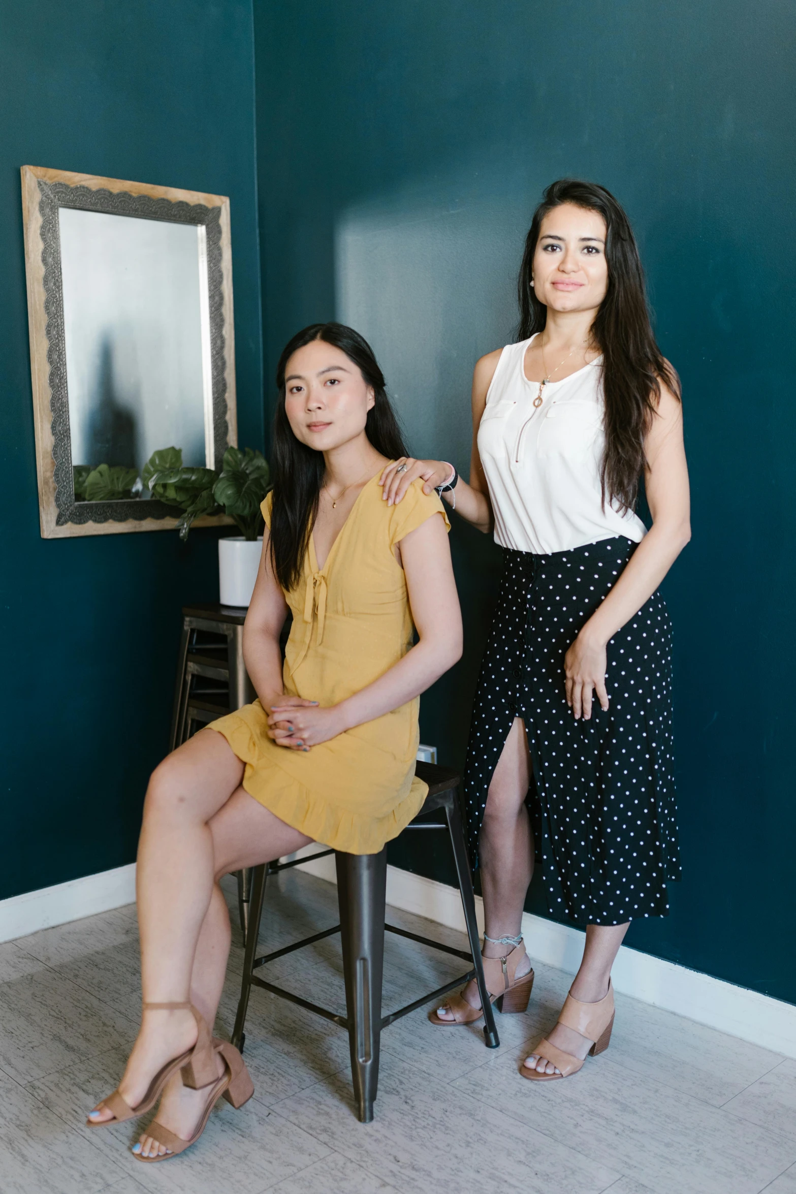 two women sitting next to each other in a room, a portrait, reddit, product shot, jen yoon, standing elegantly, sitting on a stool