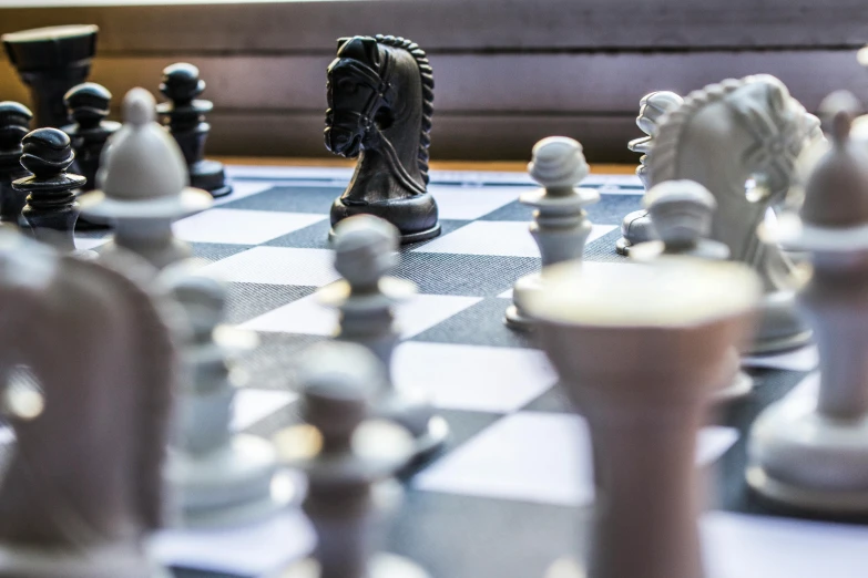 a chess board with chess pieces on it, by Daniel Lieske, unsplash, board games on a table, fighting, close - up profile, thumbnail