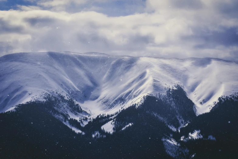 a mountain covered in snow under a cloudy sky, by Alison Geissler, pexels contest winner, hurufiyya, 1940s photo, 🌲🌌