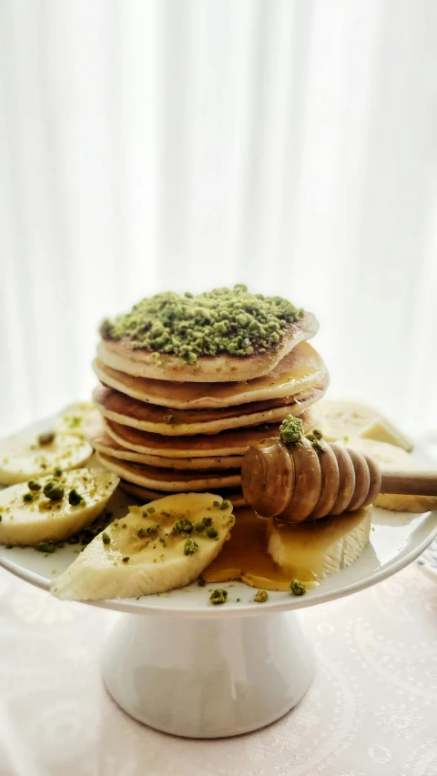 a stack of pancakes sitting on top of a white plate, by Lee Loughridge, hurufiyya, dwell, mint, banana, thumbnail