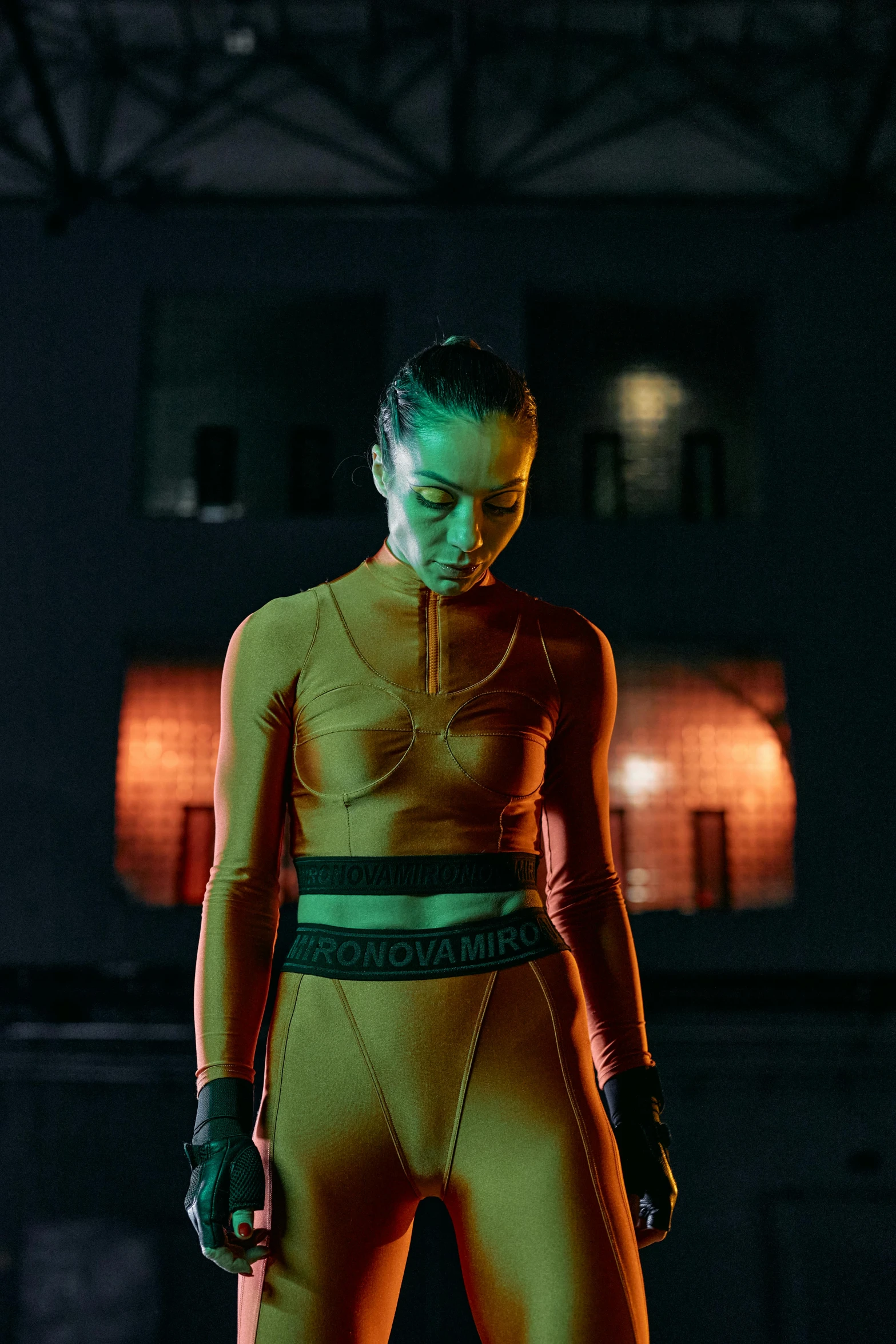 a woman that is standing in the dark, an album cover, inspired by Mike Winkelmann, pexels contest winner, nike cycling suit, wearing yellow croptop, wearing urban techwear, portrait sophie mudd