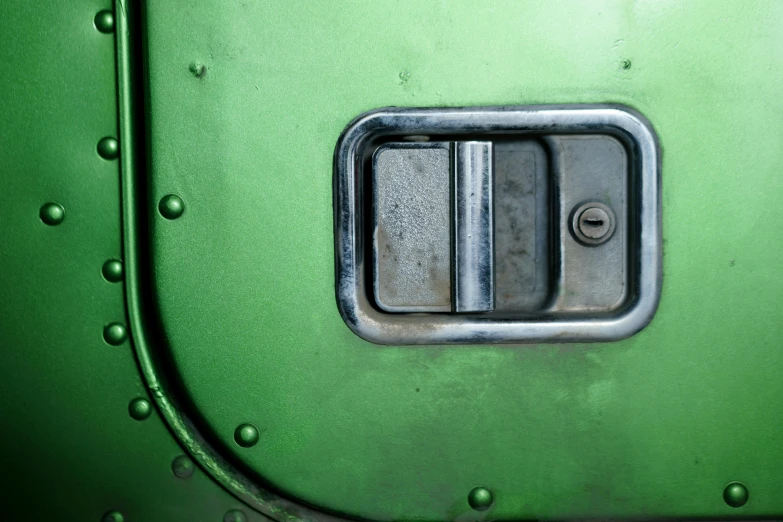 a close up of a green train door, by Adam Marczyński, unsplash, auto-destructive art, substance designer metal, rounded corners, kombi, instagram picture