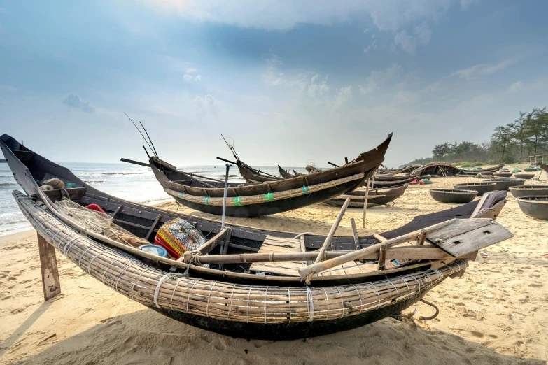 a group of boats sitting on top of a sandy beach, pexels contest winner, bengal school of art, fish seafood markets, thumbnail, slide show, profile image