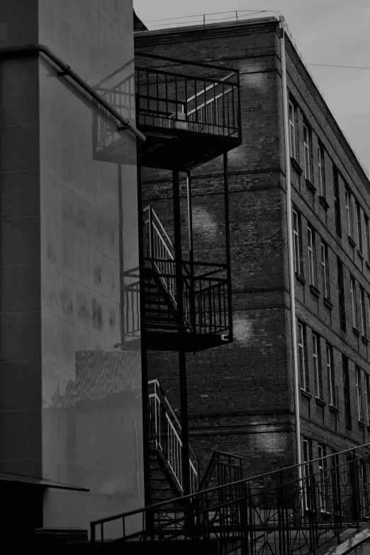 a black and white photo of a fire escape staircase, a black and white photo, inspired by Peter Basch, in empty!!!! legnica, city reflections, then another, photograph taken in 2 0 2 0