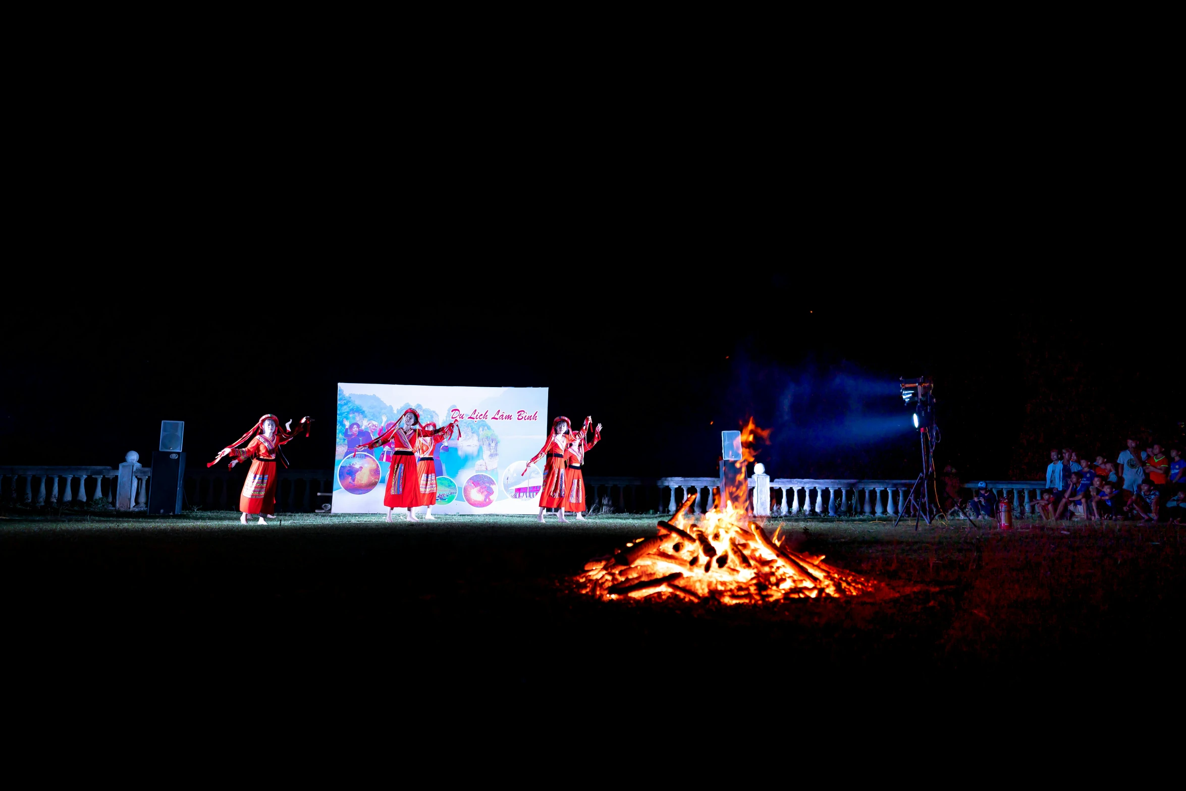 a group of people standing around a fire, interactive art, epic khajuraho, red sprites in the atmosphere, olympics ceremony, on blue fire