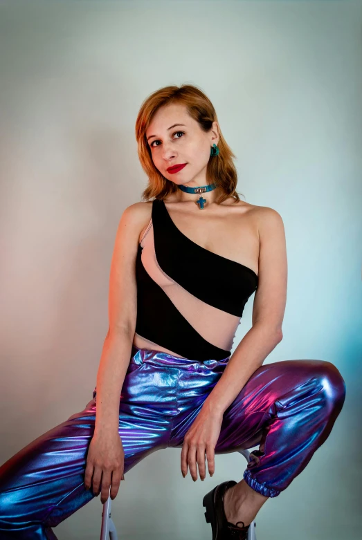 a woman sitting on a stool posing for a picture, inspired by Julia Pishtar, holography, wearing a sexy cropped top, synthwave colors!!, blue pants, alexa grace