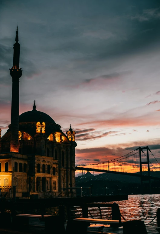 a large building sitting next to a body of water, inspired by Elsa Bleda, pexels contest winner, hurufiyya, ottoman empire, 2 5 6 x 2 5 6, city twilight landscape, burned