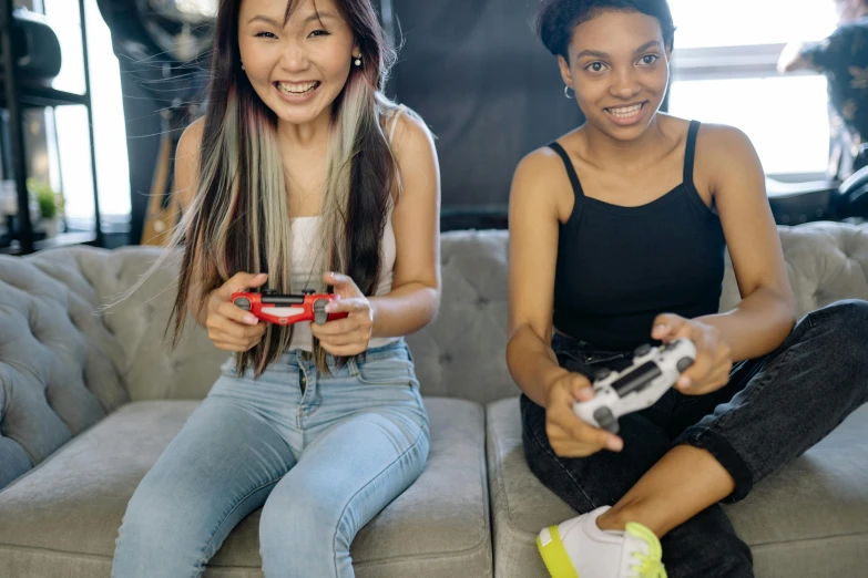 two women sitting on a couch playing video games, pexels contest winner, avatar image, wearing a cropped tops, asian descent, ps 4