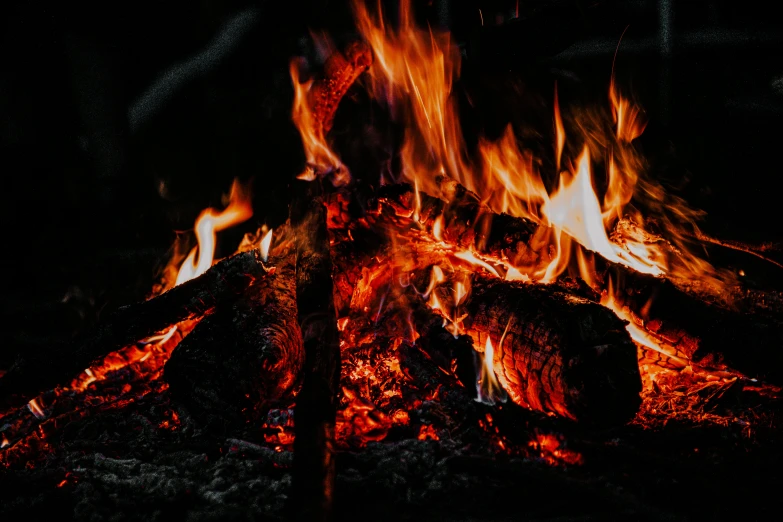 a close up of a fire in the dark, pexels contest winner, outdoor campfire pit, avatar image, background image, burning wings