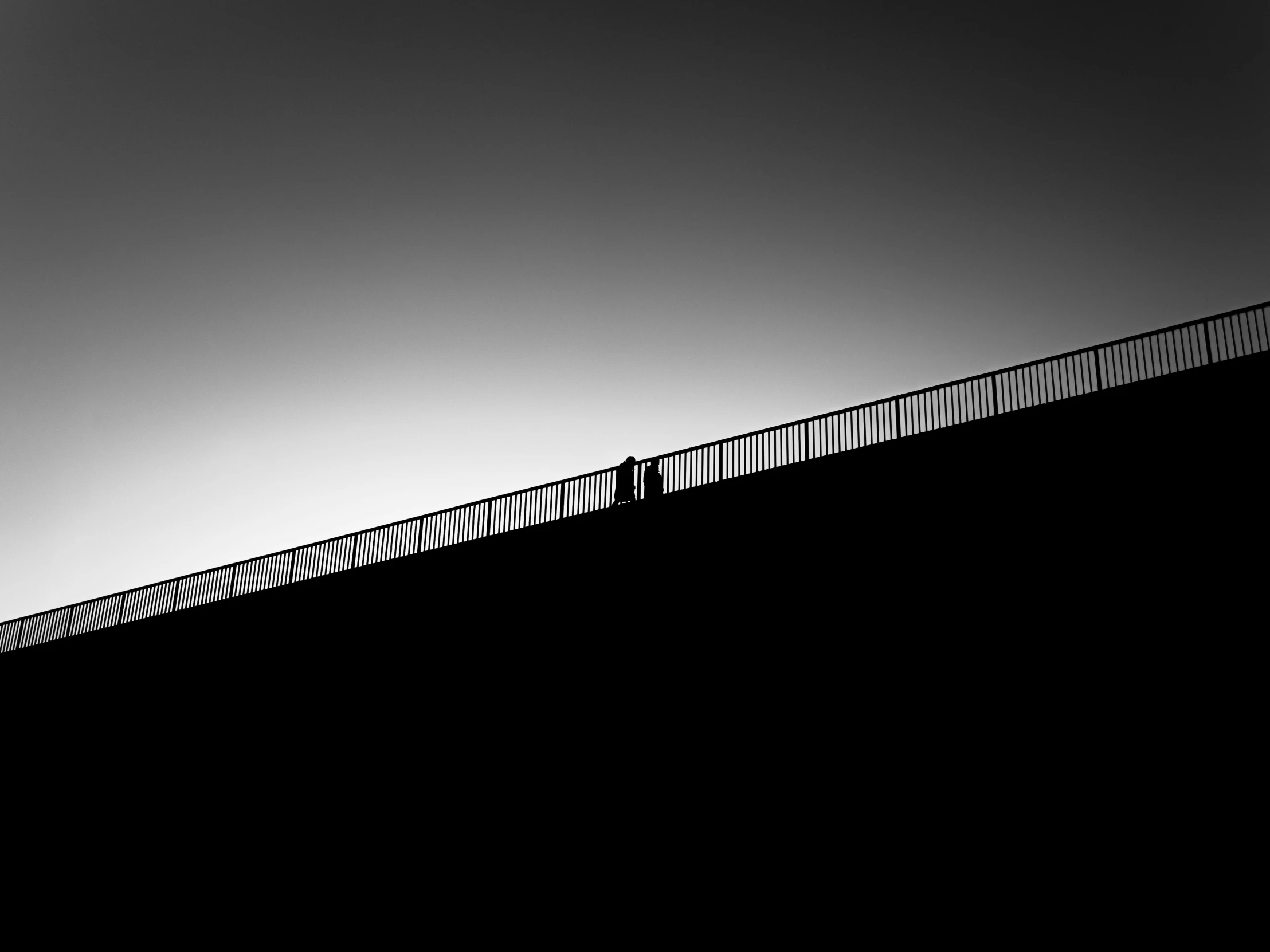 a couple of people standing on top of a bridge, by Zsolt Bodoni, minimalism, wall darkness, guardrail, fineartamerica, contre - jour