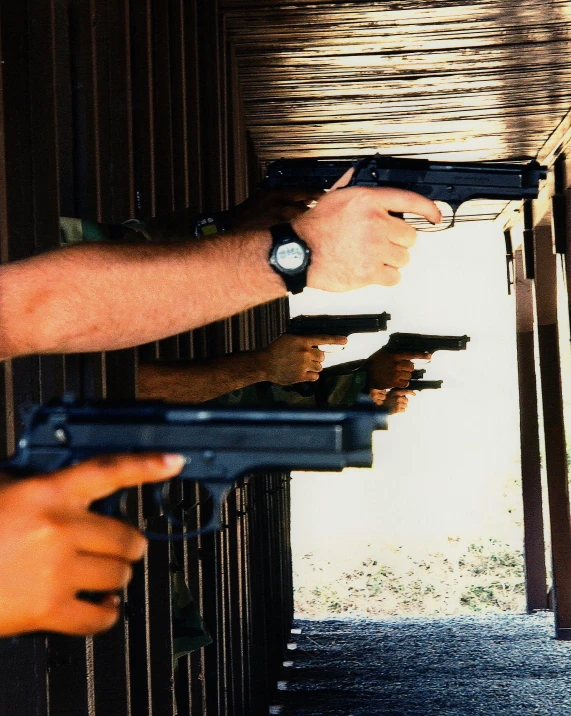 a couple of men standing next to each other holding guns, taken in the 2000s, practice, hands, overexposed photograph