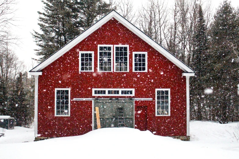 a red building sitting in the middle of a snow covered field, by Alison Geissler, pexels contest winner, folk art, in front of a garage, confetti, new hampshire, dwell