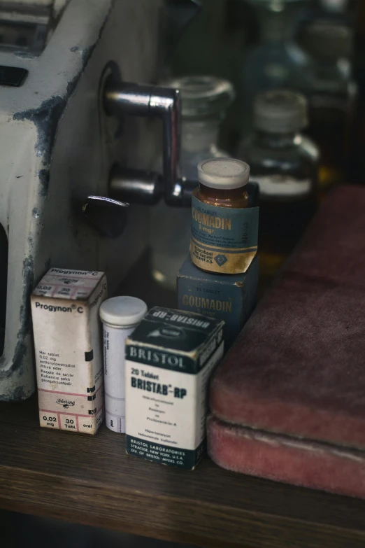 a toaster sitting on top of a wooden table, a still life, by Elsa Bleda, hyperrealism, pills and medicine, medical labels, 1960s color photograph, bottles covered in wax