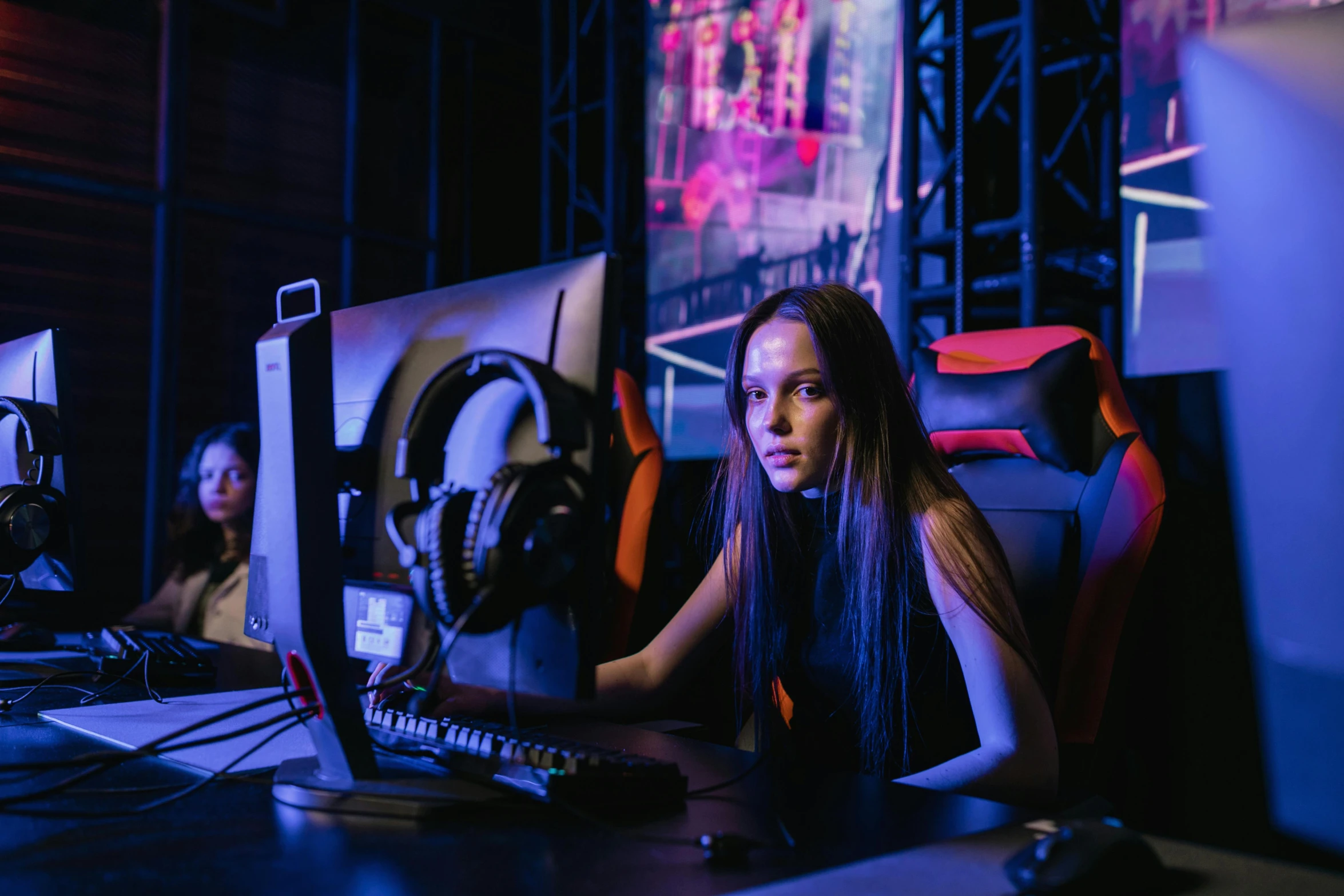 a woman sitting at a desk in front of a computer, by Adam Marczyński, e-sport style, server in the middle, profile image, hunting