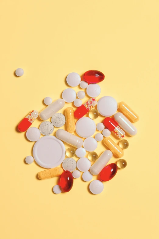 a pile of pills and capsules on a yellow background, by Chris Rahn, pexels, antipodeans, on a pale background, 10k, formulas, 1x