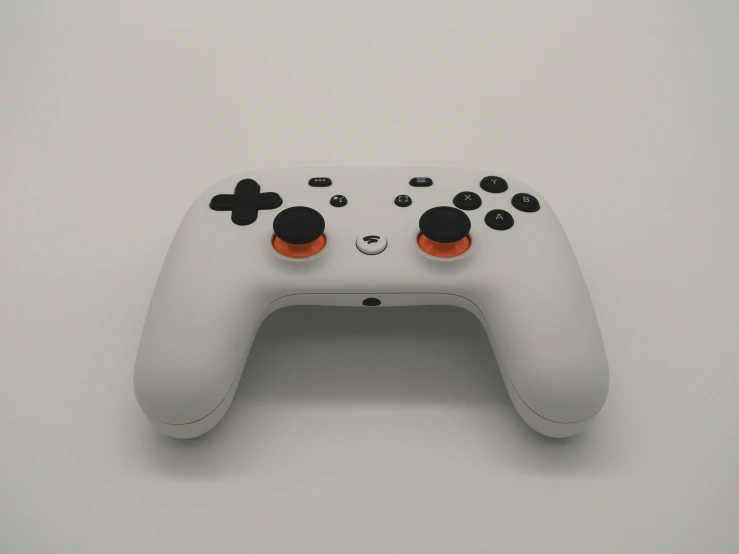 a close up of a video game controller, an ambient occlusion render, unsplash, grey orange, google point of view, on a white table, steam workshop