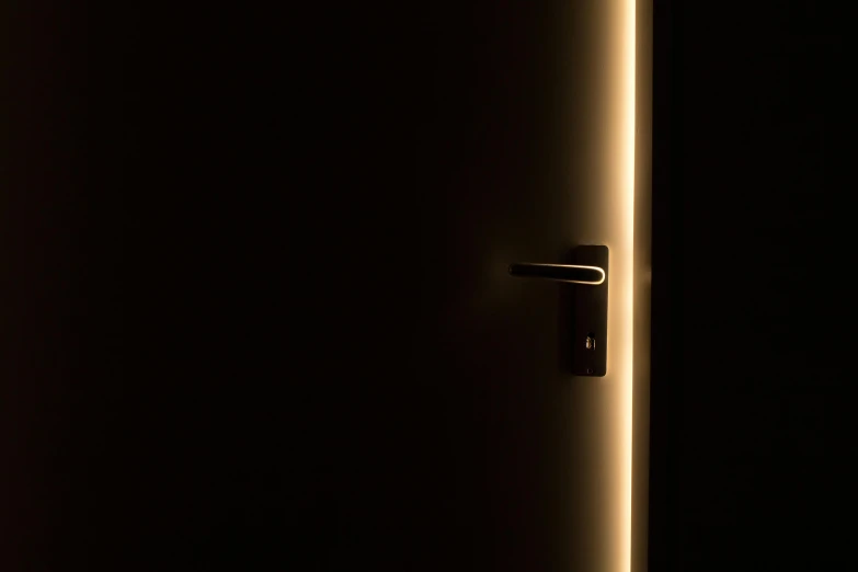 a close up of a door in a dark room, by Thomas Häfner, light and space, nightlight, warm illumination, metallic light, key lighting