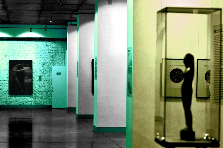 a black and white photo of a person in a green room, arte povera, set in bank vault room, colorized photon, dongson bronze artifacts, infinite hallways