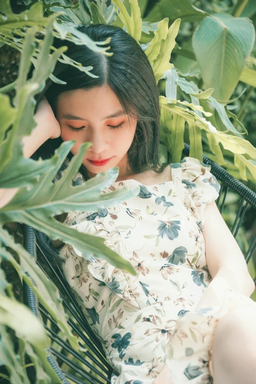 a woman sitting in a chair surrounded by plants, a picture, by Tan Ting-pho, trending on pexels, short sleeves, ulzzang, summer color pattern, thoughtful )