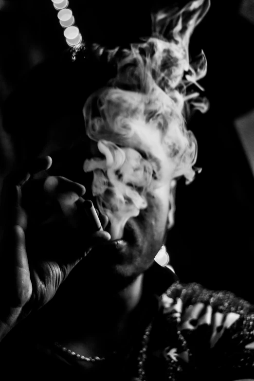 a black and white photo of a man smoking a cigarette, by Davide Sasselli, personification of marijuana, blazing infero, 2 1 savage, ..'