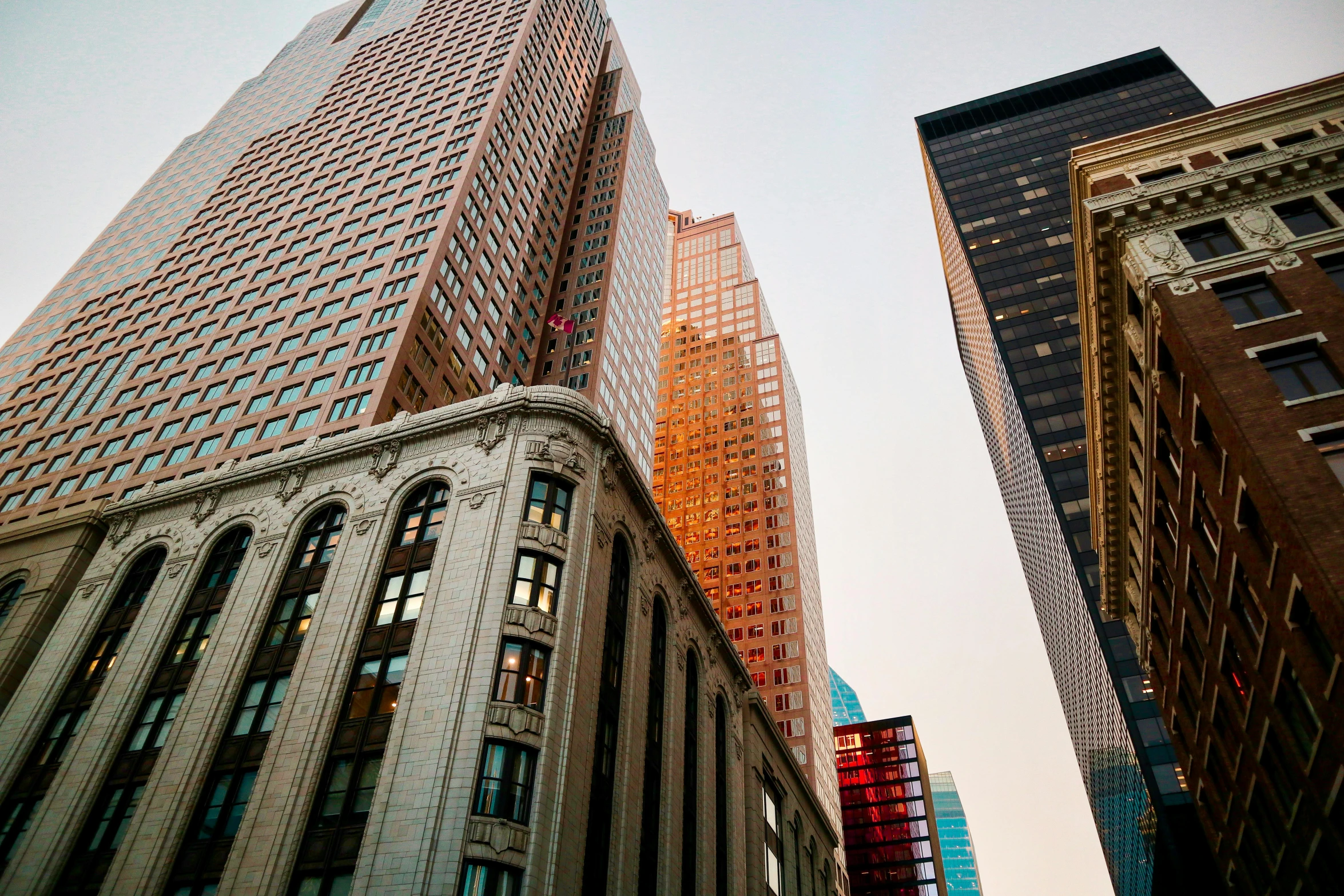 a couple of tall buildings sitting next to each other, by Andrew Domachowski, pexels contest winner, pink marble building, louis sullivan, ad image, location [ chicago ( alley ) ]