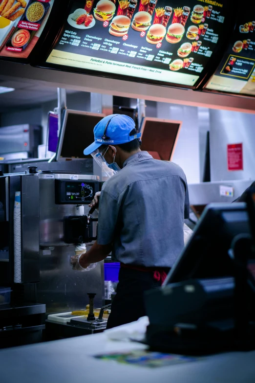 a man working in a fast food restaurant, by William Berra, pexels, blue mcdonalds, robotics, early in the morning, thumbnail