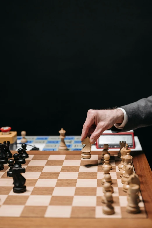 a man in a suit playing a game of chess, unsplash, photograph credit: ap, jen atkin, robotics, a wooden