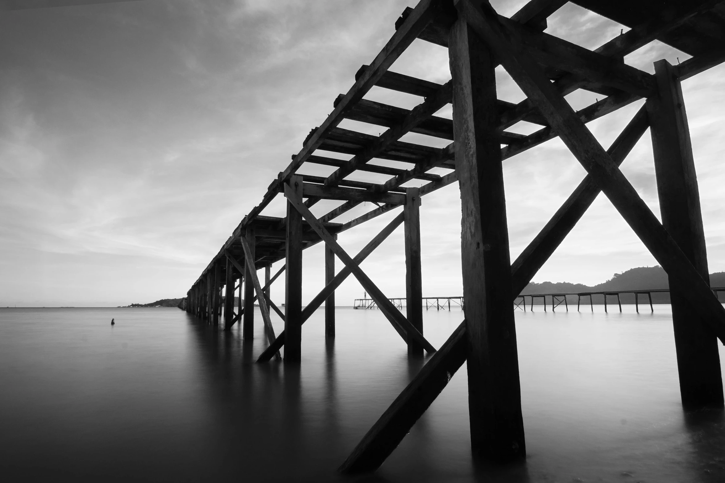 a black and white photo of a pier, unsplash, rusted, medium format, construction, wooden supports