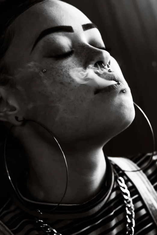 a black and white photo of a woman with her eyes closed, a black and white photo, trending on pexels, smoking a joint, piercings collar, ganja, photograph of a techwear woman