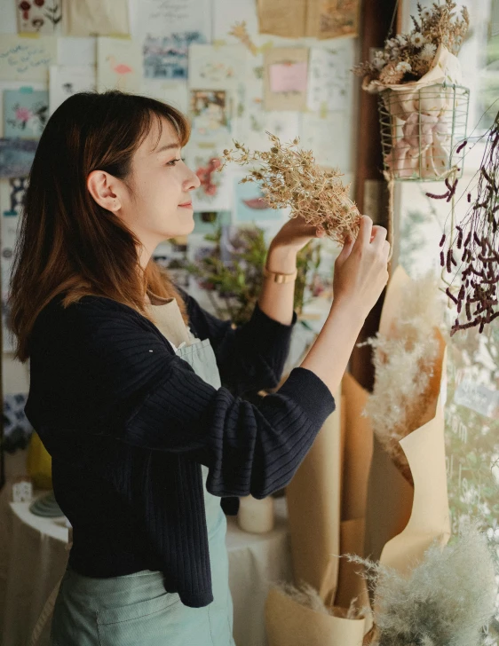 a woman holding a bunch of dried flowers, a picture, trending on unsplash, arts and crafts movement, inspect in inventory image, portrait of lain iwakura, hanging, cute photo