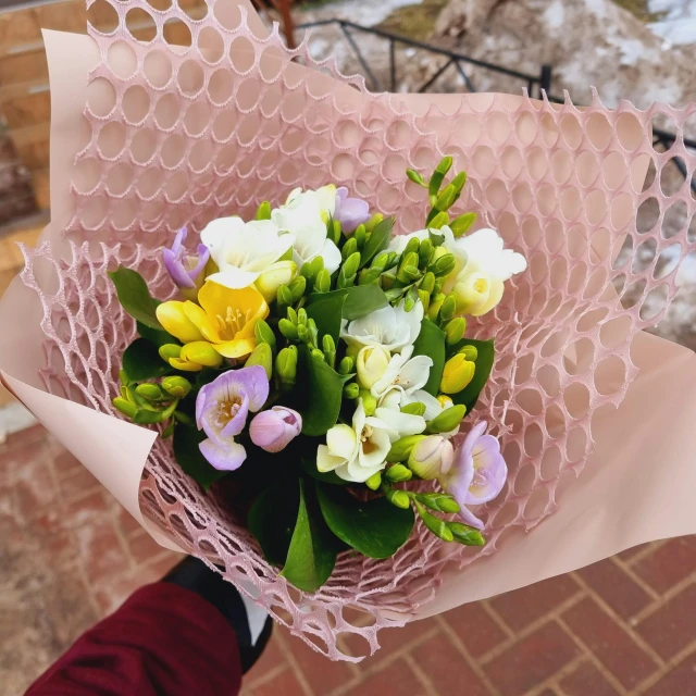 a close up of a person holding a bouquet of flowers, honeycomb, spring colors, wintertime, small in size