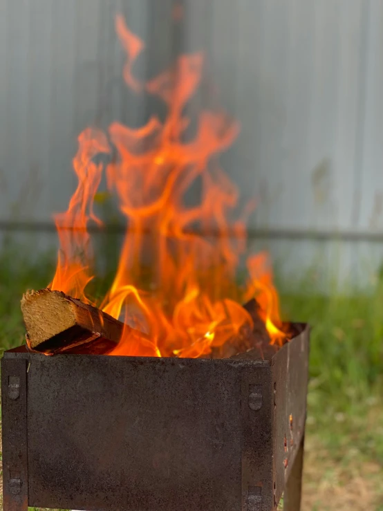 a fire that is burning in the grass, an album cover, by Jan Rustem, unsplash, renaissance, barbecue, background image, rusty, high quality product image”