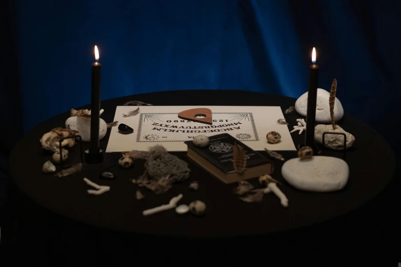 a couple of candles sitting on top of a table, an album cover, by Julia Pishtar, pexels contest winner, surrealism, inscribed with occult symbols, bones lying on the ground, miniature product photo, kramskoi 4 k