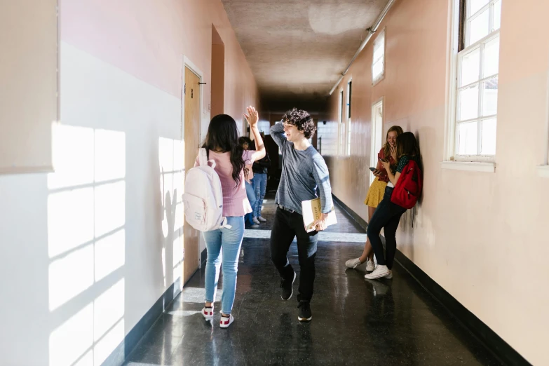 a group of people walking down a long hallway, pexels contest winner, ashcan school, bullying, background image, school courtyard, dancing with each other