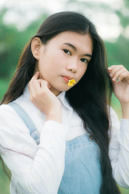 a woman standing in a field with a flower in her mouth, by Tan Ting-pho, unsplash, realism, portrait of high school girl, 🤤 girl portrait, yellow, snacks